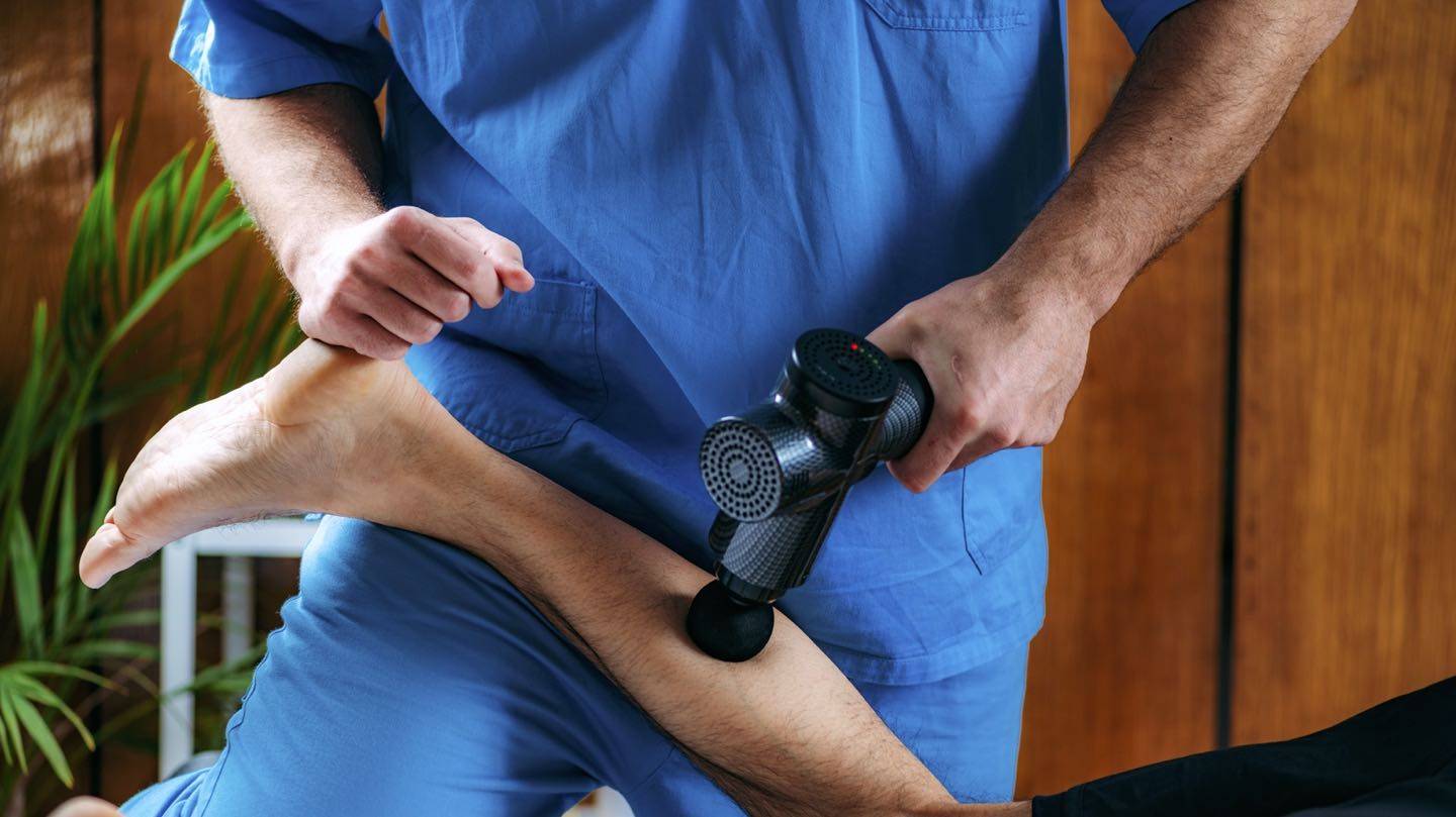 Massage Gun used on thigh