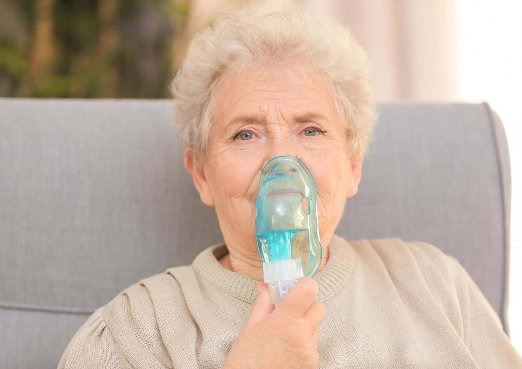 Woman with nebuliser mask