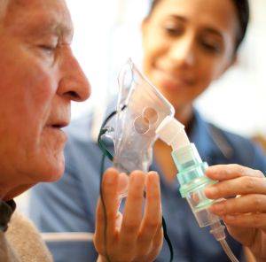 Senior using a nebuliser