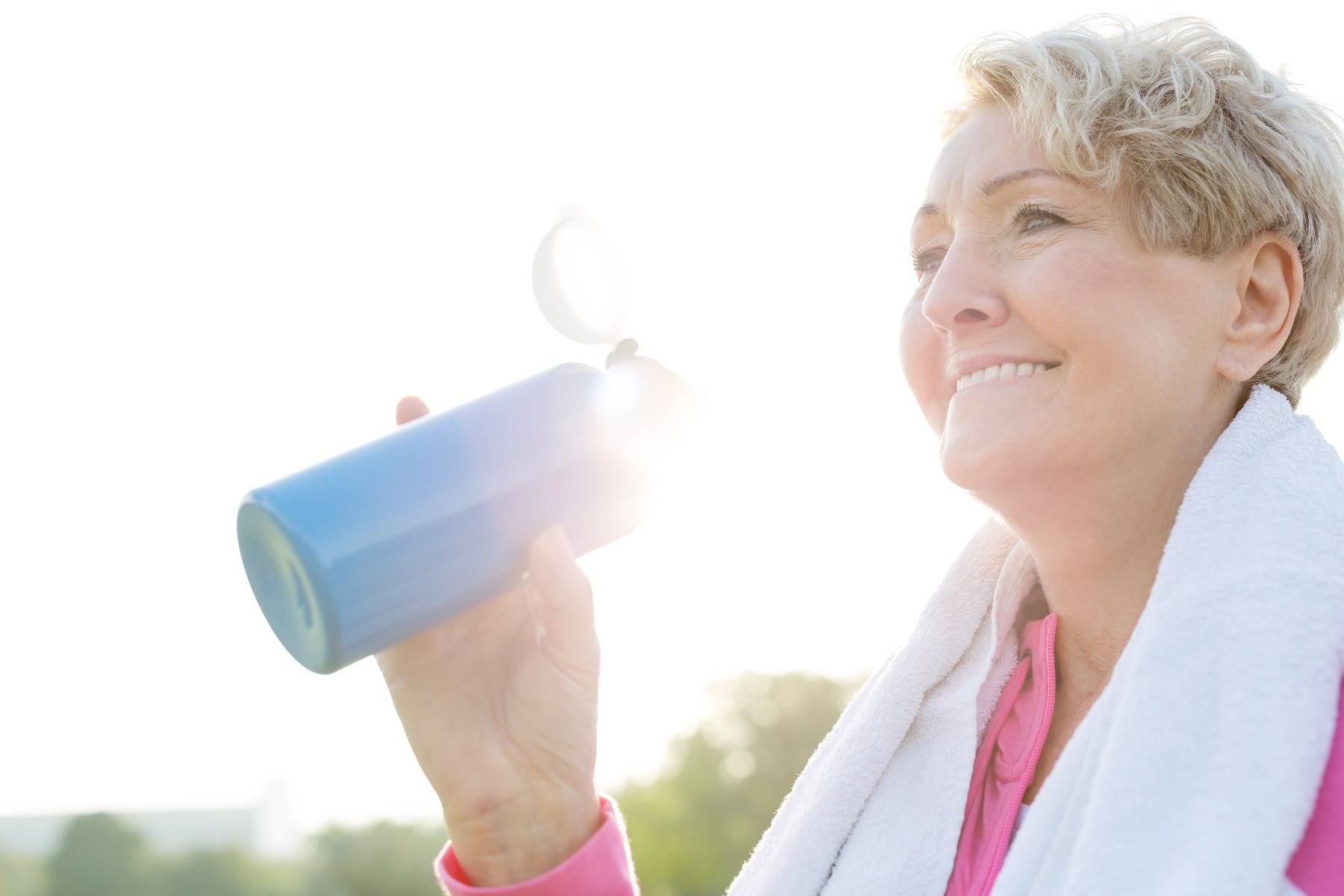 Woman with water bottle after exercise